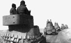 Подразделение броневиков на марше. На переднем плане - бронеавтомобиль БА-6, на заднем - БА-10. На корпусах боевых машин уложены гусеничные ленты "Оверолл". Западный фронт, 1942 год.