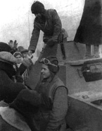Разведывательный лёгкий бронеавтомобиль БА-64 на углу пересечения Крещатика и улицы Саксаганского. Судя по коричневым кожаным жилетам-безрукавкам английского производства, которые одеты на членах экипажа бронемашины, разведгруппа принадлежит 48-му гвардейскому отдельному полку прорыва, оснащённому британскими танками типа MK IV «Черчилль». Украина, ноябрь 1943 года.