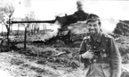 Оберфельдфебель на фоне подбитого им танка ИС-2. 1944 год.