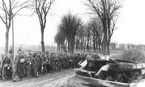 Колонна пленных немецких солдат. Справа - остов взорвавшегося танка ИС-2. Р-н оз. Балатон, апрель 1945 г.