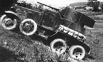 Опытный образец бронеавтомобиля БА-3 преодолевает подъём во время испытаний. На правом крыле видна укладка вездеходных цепей "Оверолл", закрытых брезентом. НИБТ полигон, лето 1934 года.