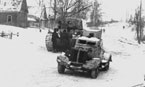 Бронеавтомобиль ФАИ-М и танк КВ-1 (на заднем плане) на улице одной из деревень в пригороде Москвы. Западный фронт. 5 армия, 22-я танковая бригада, ноябрь 1941 года.