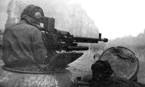 Командир танка ИС-2 ведёт огонь из зенитного пулемёта по вражеским гренадёрам. 11 гв. ттп. Данциг, апрель 1945 года.